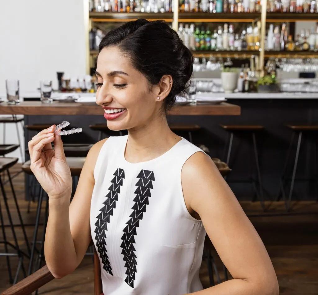 Happy women holing Invisalign