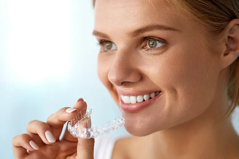 Happy women holing Invisalign
